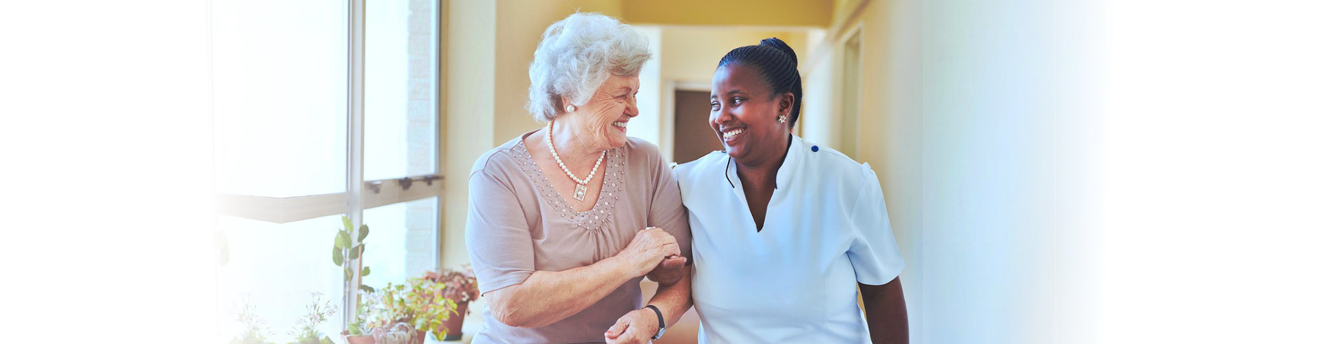 caregiver and senior woman walking