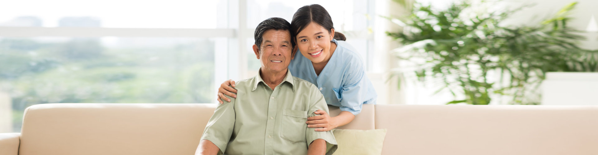 caregiver and senior man smiling